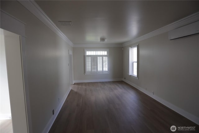 422 Chenault Ave, Hoquiam, WA 98550 - spare room featuring visible vents, baseboards, wood finished floors, a wall mounted AC, and ornamental molding
