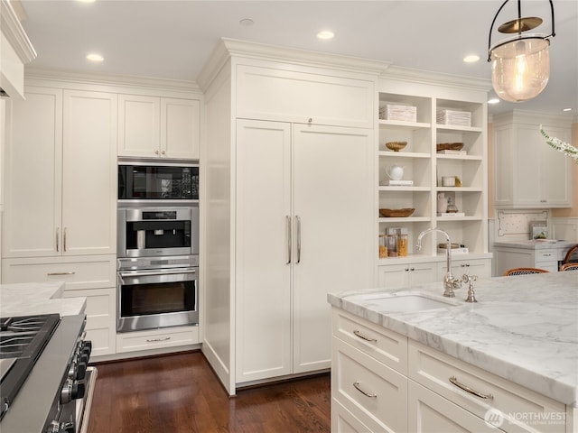 kitchen featuring dark wood-style floors, white cabinetry, built in microwave, a sink, and high end range