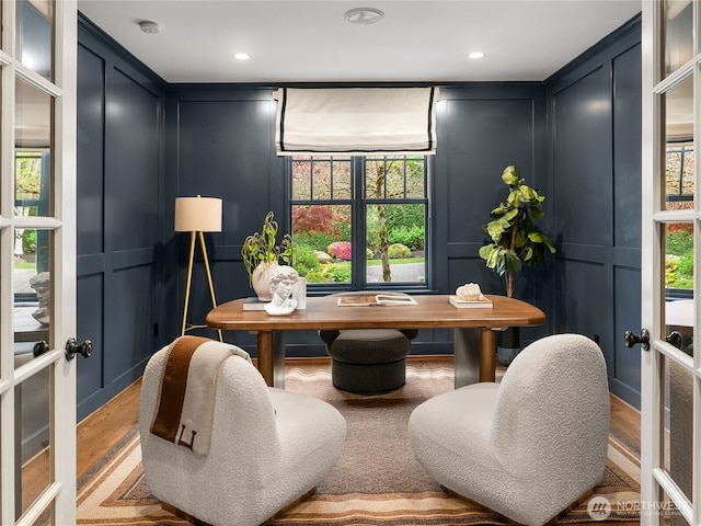 home office with wood finished floors, recessed lighting, and a decorative wall