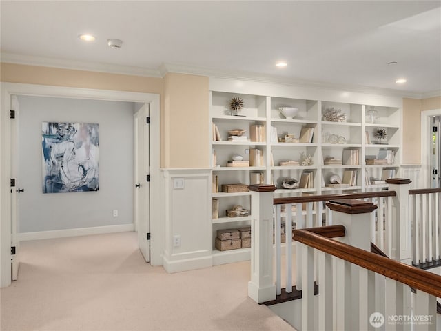 corridor with recessed lighting, an upstairs landing, ornamental molding, and carpet