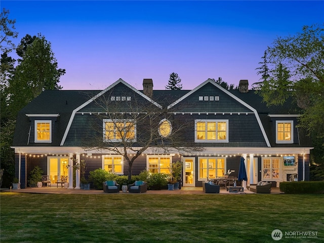 back of property with a patio area, french doors, and a chimney