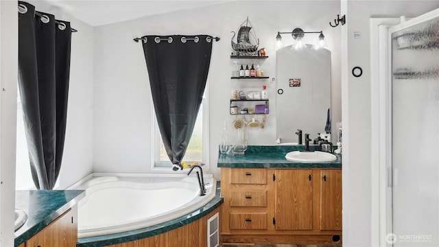 full bath featuring vanity, a bath, and a shower stall