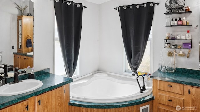 bathroom with a bath and vanity