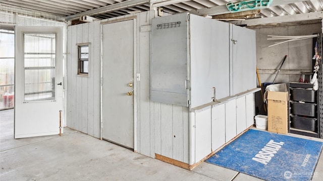 miscellaneous room with unfinished concrete flooring