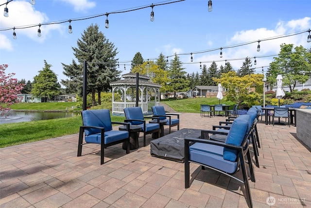 view of patio with a gazebo and a water view