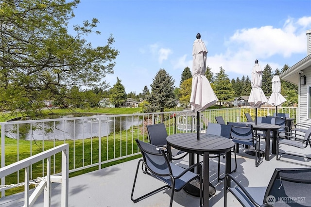 view of patio / terrace with outdoor dining space and a water view