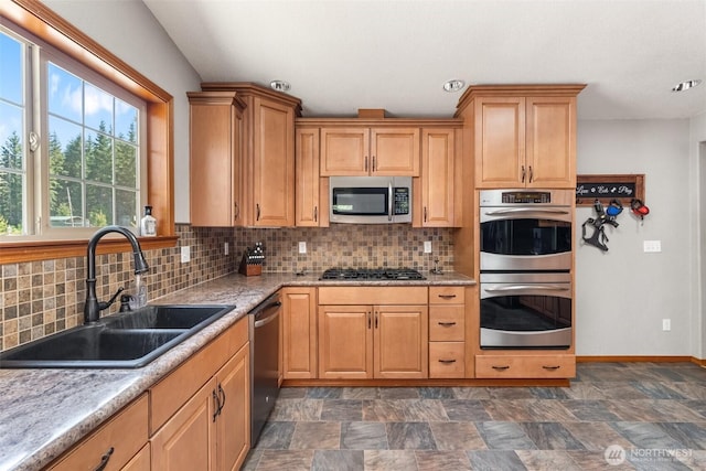 12430 Brooks St SW, Olympia, WA 98512 - kitchen with a sink, appliances with stainless steel finishes, backsplash, and stone finish flooring