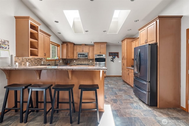 12430 Brooks St SW, Olympia, WA 98512 - kitchen featuring decorative backsplash, appliances with stainless steel finishes, open shelves, light stone countertops, and a peninsula