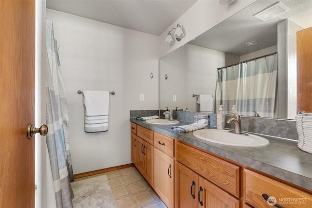12430 Brooks St SW, Olympia, WA 98512 - full bathroom with a sink, baseboards, double vanity, and visible vents
