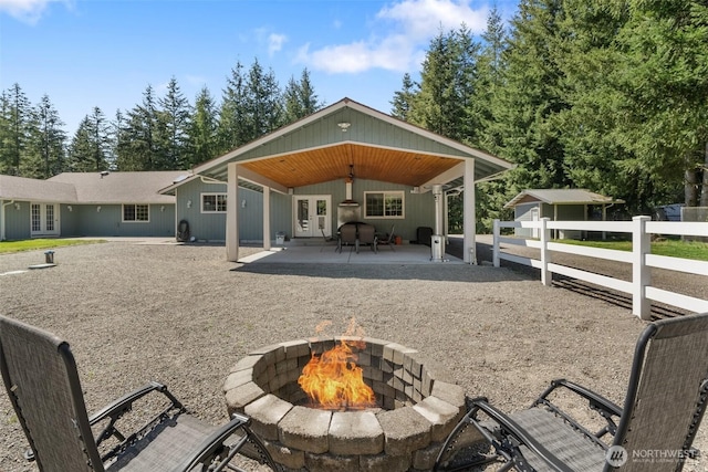 12430 Brooks St SW, Olympia, WA 98512 - back of house with fence, french doors, a patio area, and an outdoor fire pit