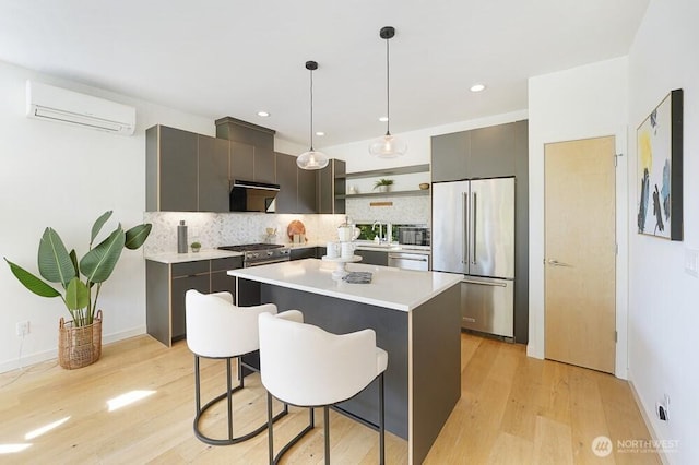 3236 W Government Way, Seattle, WA 98199 - kitchen with open shelves, a wall mounted air conditioner, high quality appliances, light wood-style flooring, and backsplash