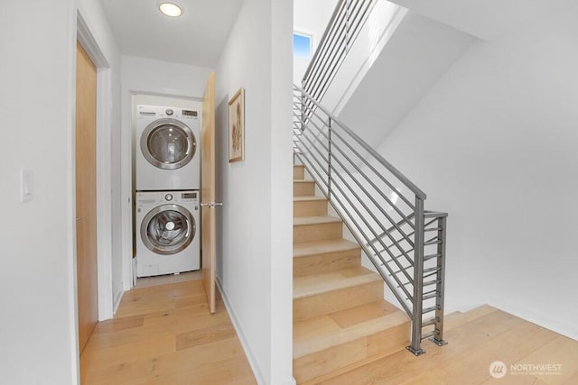 3236 W Government Way, Seattle, WA 98199 - staircase with recessed lighting, stacked washing maching and dryer, and wood finished floors