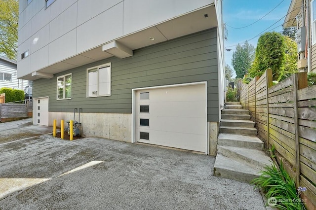 3236 W Government Way, Seattle, WA 98199 - garage featuring fence and driveway
