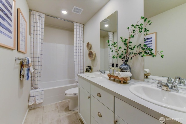 bathroom featuring toilet, tile patterned floors, visible vents, and a sink