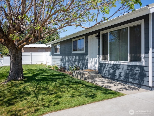 exterior space with fence and a front yard