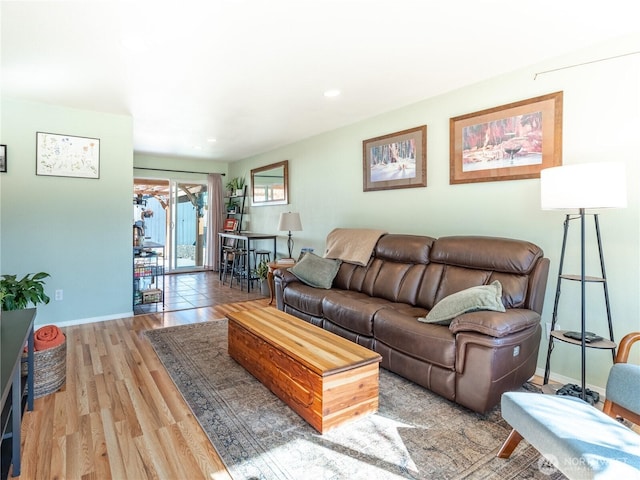 living room featuring recessed lighting, baseboards, and light wood-style floors