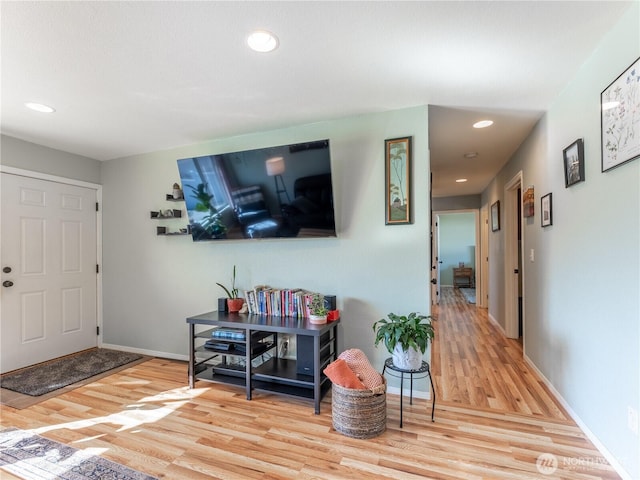 foyer entrance featuring baseboards, recessed lighting, and wood finished floors