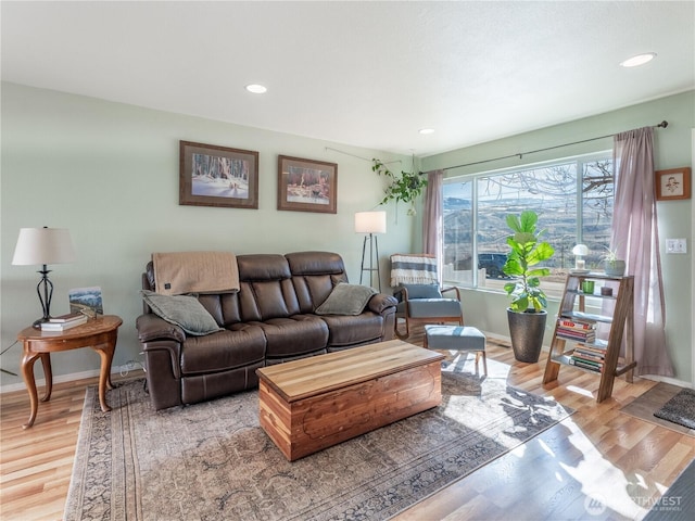 living room featuring baseboards, recessed lighting, and wood finished floors