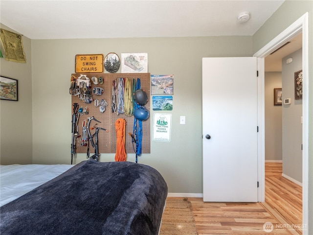 bedroom featuring baseboards and light wood-style flooring