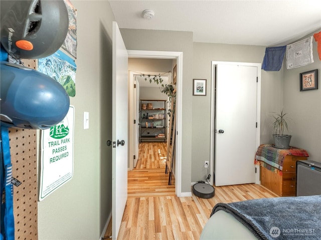 bedroom with baseboards and light wood-style flooring