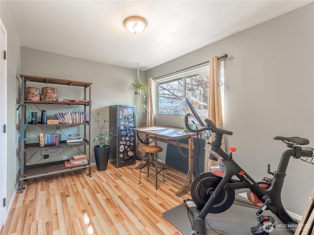 office space with baseboards and wood finished floors
