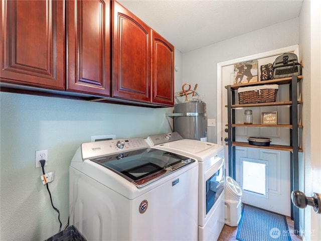 washroom with separate washer and dryer, cabinet space, and secured water heater