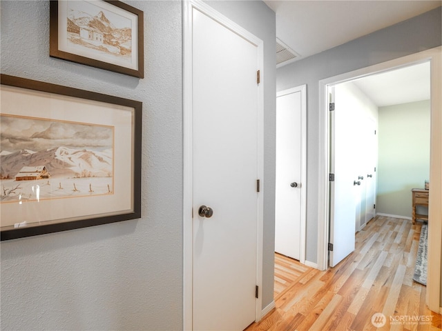 corridor featuring light wood-style floors