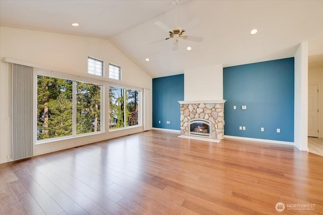 unfurnished living room with ceiling fan, a fireplace, high vaulted ceiling, light wood-style floors, and recessed lighting