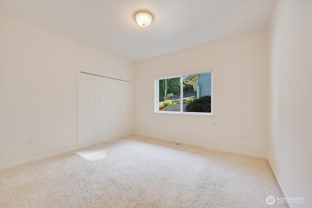 empty room with baseboards and carpet