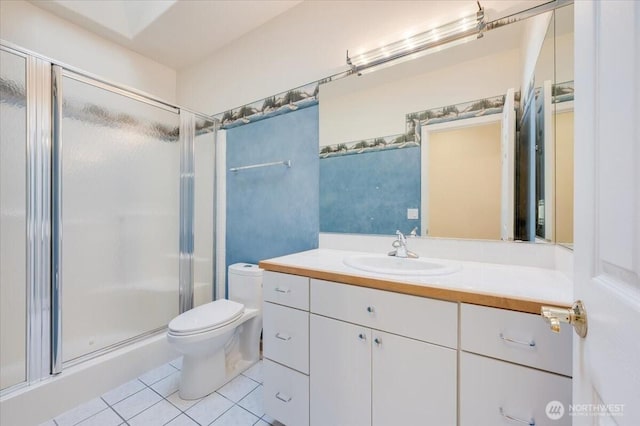 full bathroom with vanity, tile patterned floors, toilet, and a shower stall
