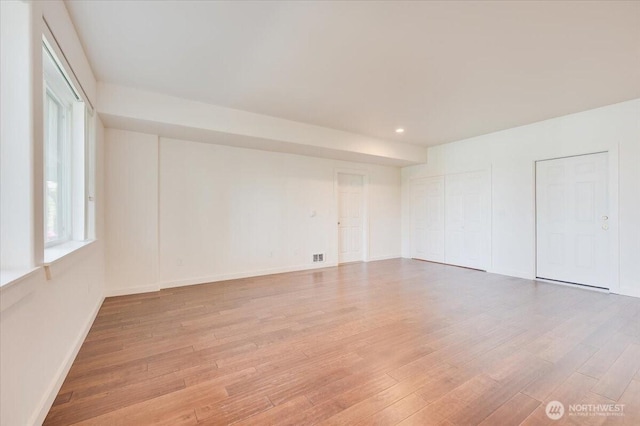 spare room featuring recessed lighting, baseboards, and light wood-type flooring