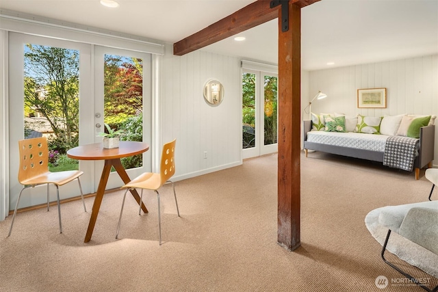 sunroom featuring a healthy amount of sunlight, french doors, and beam ceiling