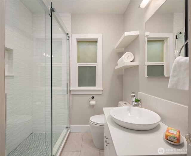 bathroom featuring vanity, toilet, tile patterned floors, and a stall shower