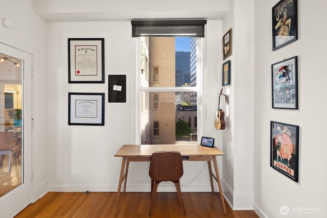 office space with baseboards and wood finished floors