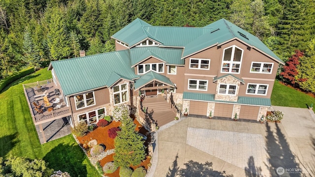 15803 Uplands Way SE, North Bend, WA 98045 - view of front of house with a forest view, stone siding, metal roof, and a chimney
