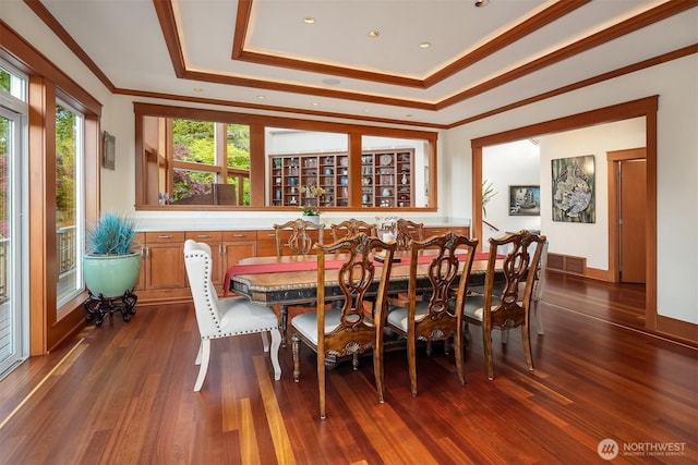 15803 Uplands Way SE, North Bend, WA 98045 - dining room with a tray ceiling, crown molding, dark wood-style flooring, and baseboards