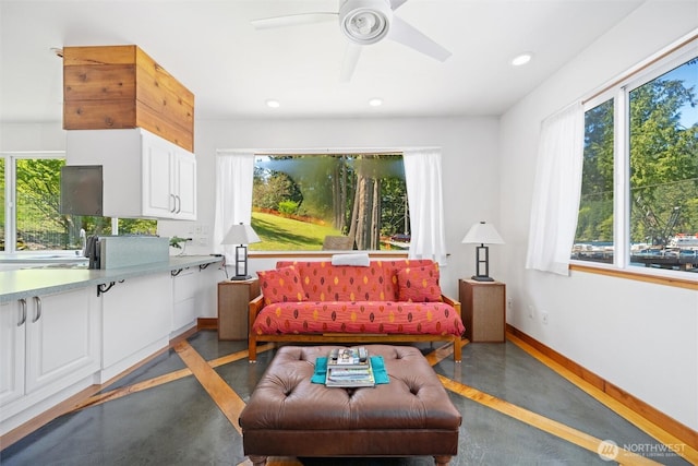 living area featuring finished concrete floors, a healthy amount of sunlight, and recessed lighting