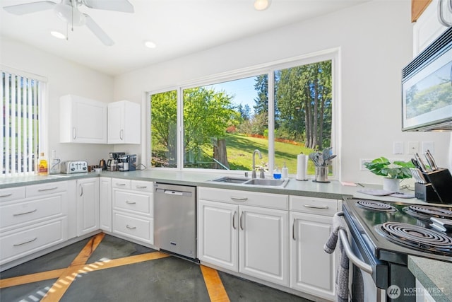 kitchen with a sink, recessed lighting, ceiling fan, white cabinetry, and appliances with stainless steel finishes