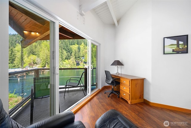 office space with a water view, a wealth of natural light, and hardwood / wood-style floors