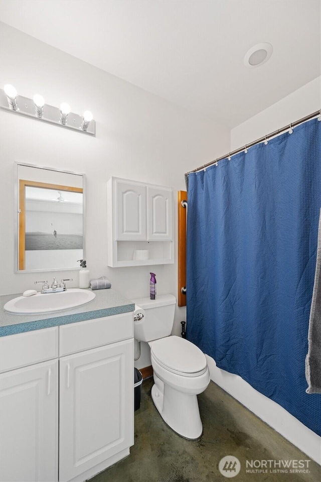 bathroom featuring toilet, concrete flooring, vanity, and a shower with curtain