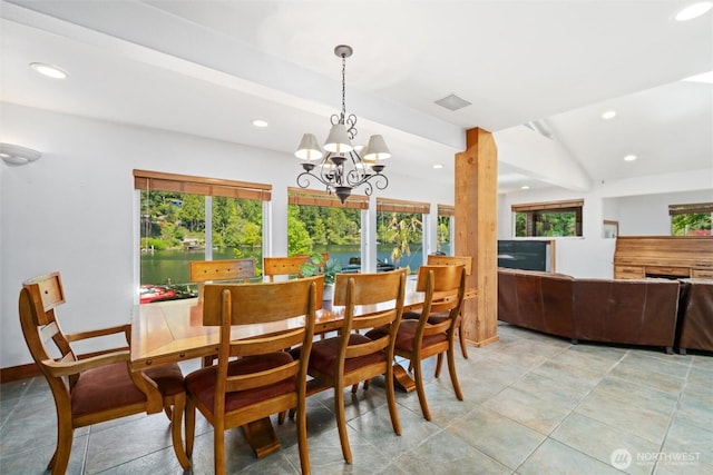 dining space featuring a chandelier, a water view, a healthy amount of sunlight, and recessed lighting