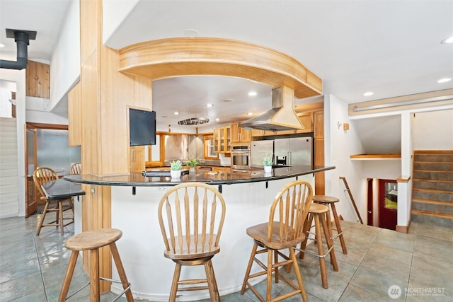 kitchen with recessed lighting, glass insert cabinets, island exhaust hood, dark countertops, and stainless steel appliances