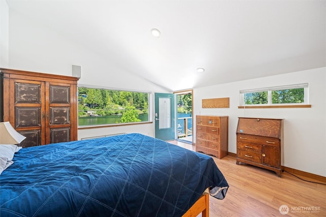 bedroom featuring multiple windows, vaulted ceiling, light wood-style flooring, and baseboards