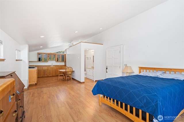 bedroom with recessed lighting, light wood-style flooring, connected bathroom, and vaulted ceiling