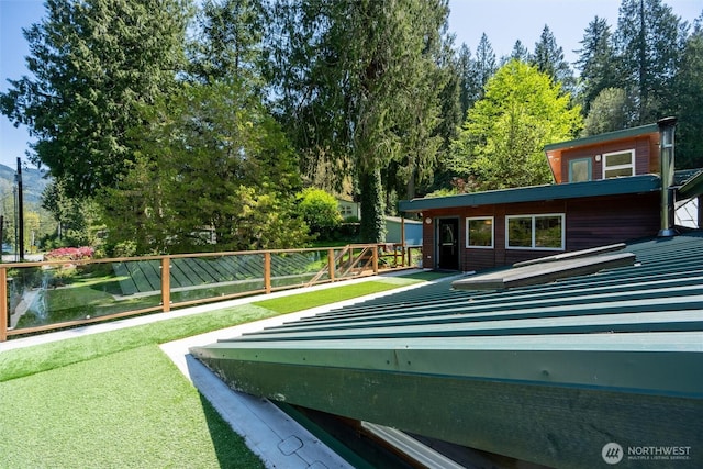 view of swimming pool with a yard and fence