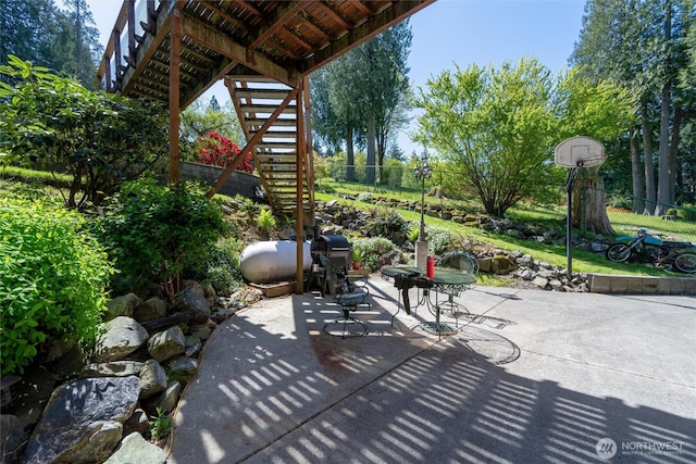 view of patio with stairway and a fenced backyard