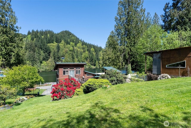 view of yard with a wooded view