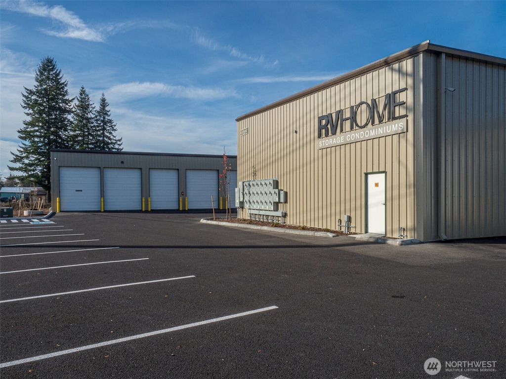view of building exterior featuring uncovered parking