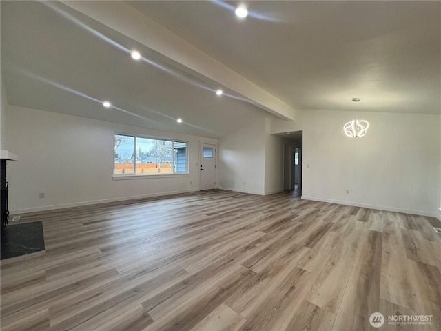 unfurnished living room with baseboards, vaulted ceiling with beams, light wood-style flooring, and a chandelier