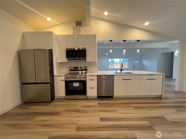 kitchen with visible vents, modern cabinets, light countertops, a sink, and stainless steel appliances